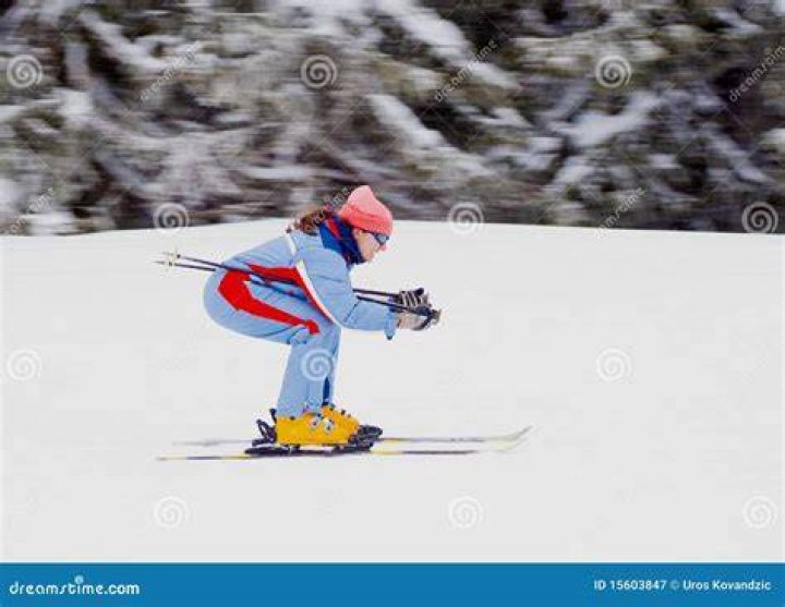 A Women Skiing Down The Mountain