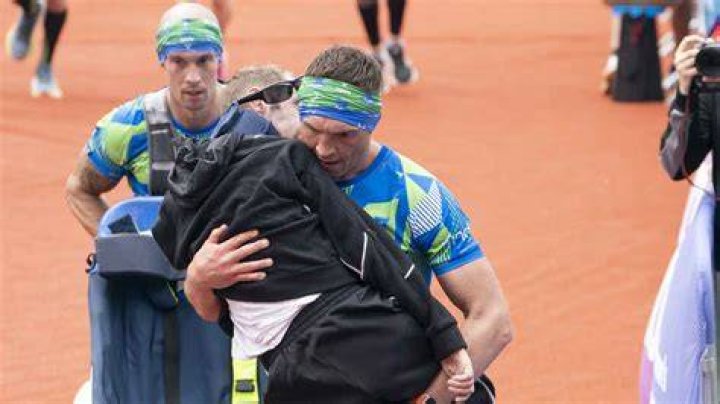 An emotional Kevin Sinfield carries Rob Burrow over the finish line at the inaugural Rob Burrow Leeds Marathon