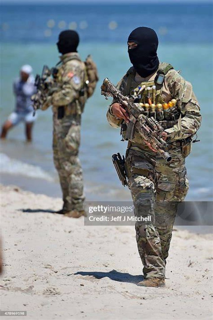  Armed guards patrol Marhaba beach on June 29, 2015 during a visit by Theresa May at the scene where 38 people were killed