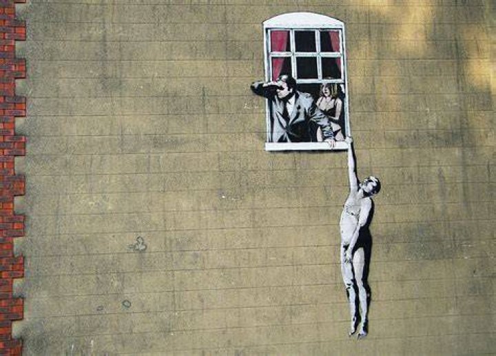 Banksy's artwork showed the silhouette of a boy pushing apart iron curtains as a cat looked on