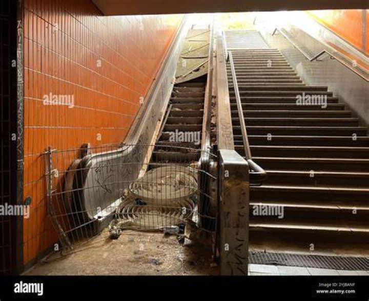  Commuters use the broken escalator despite warnings it is closed