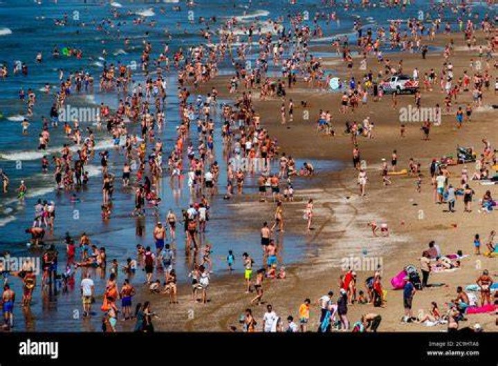 Crowds enjoy the warm weather ahead of the Bank Holiday weekend at Durdle Door in Dorset
