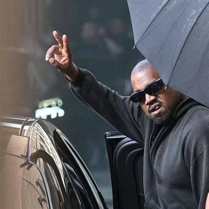 Despite the European heat, Kanye wrapped his head in a sweater and wore an-all black outfit