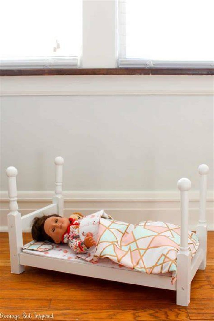 girl on bed with doll with dog