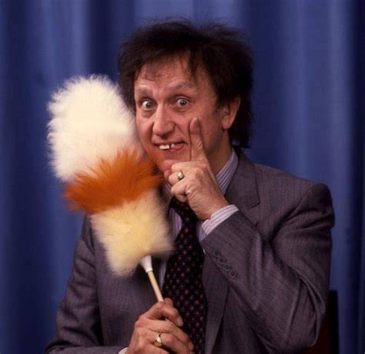 Ken Dodd with his golden disc for 100,000 copies of his record sold 'Tears' presented to him in his dressing room at the London Palladium