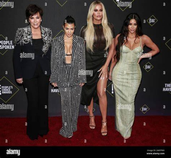 Kris Jenner, Kourtney Kardashian, Khloe Kardashian, and Kim Kardashian posing on the red carpet.