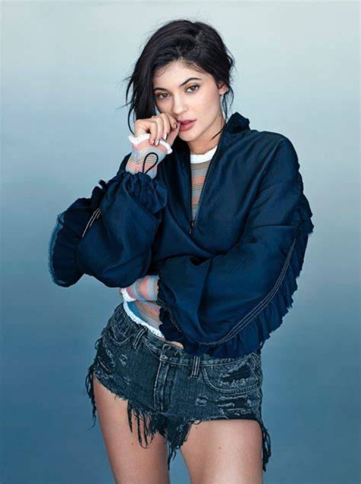  Kylie Jenner poses in a thong with a snake coiled around her for 2017 calendar