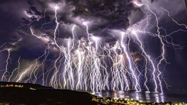 Lightning strikes were snapped over Poole in Dorset from the Isle of Wight last night