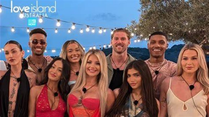 Love Island season 5 contestant Johnnie Garcia wearing yellow shirt and skirt and headphones