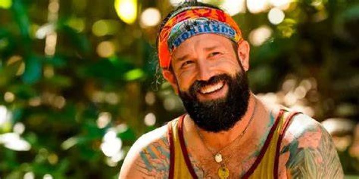  Matthew Grinstead-Mayle from Survivor season 44 posing in costume and smiling
