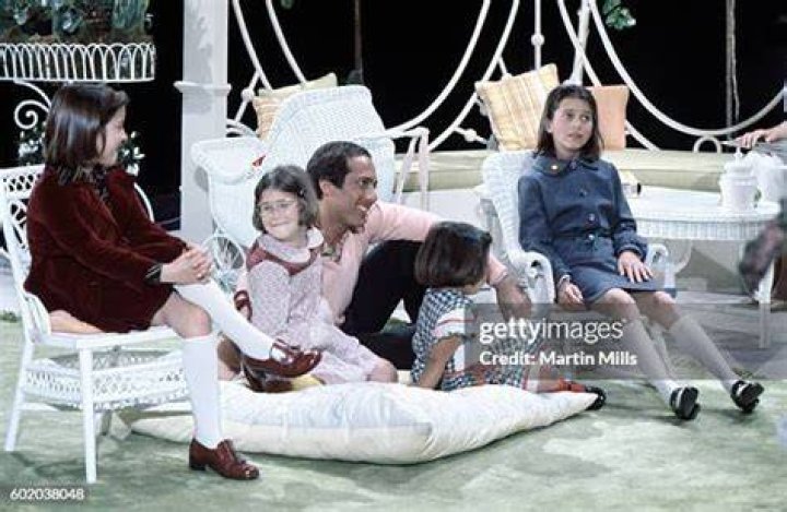 Musician Paul Anka sits with four of his daughters during a photo...