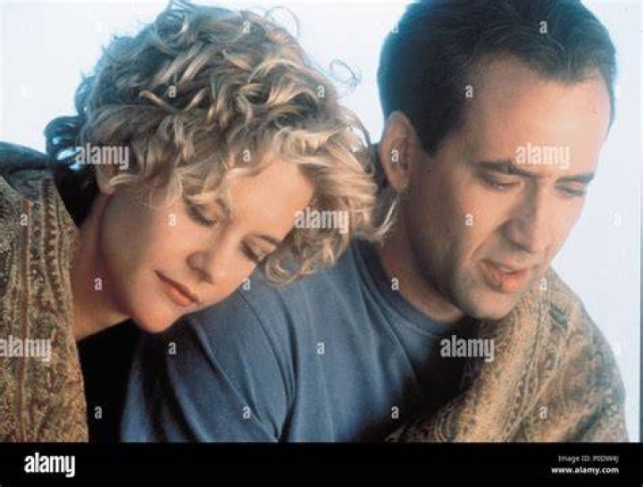 Nicolas Cage heals Meg under the hook.
