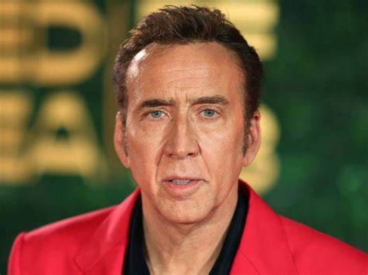 Nicolas Cage vaults a pallet with Meg behind him.