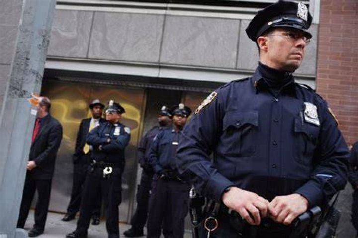 Police officers stand guard at the school gates