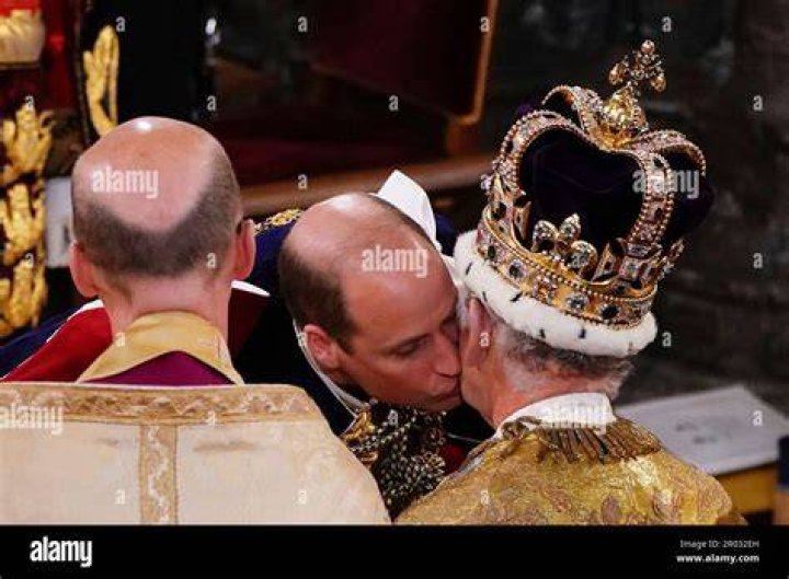 Prince William kisses his father King Charles