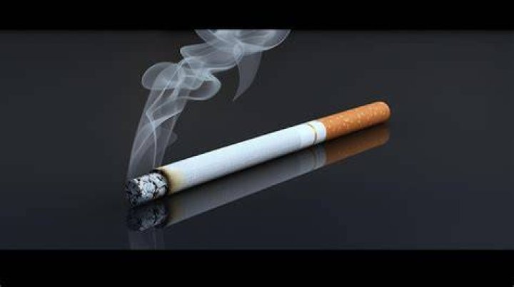  The cigarette is lit then placed in the statue's mouth