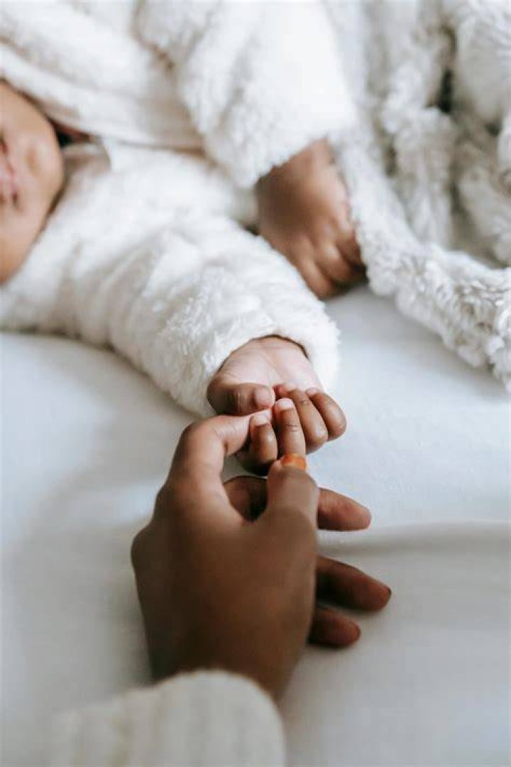  The mum is looking after her baby who like all kids her age is having a bit of a bawl