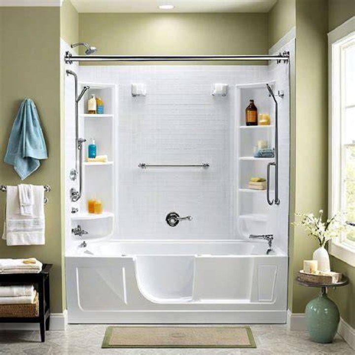 The tub is in the floor of the bathroom