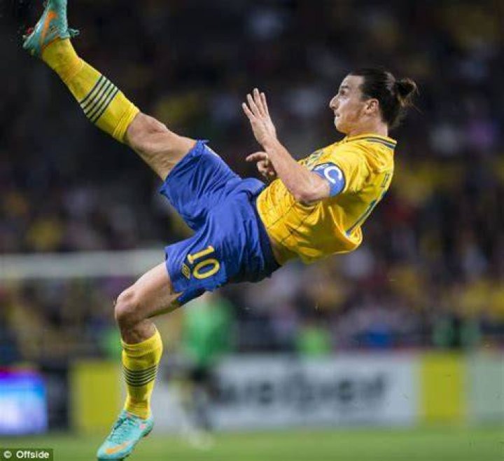 Zlatan showing off his back tattoo